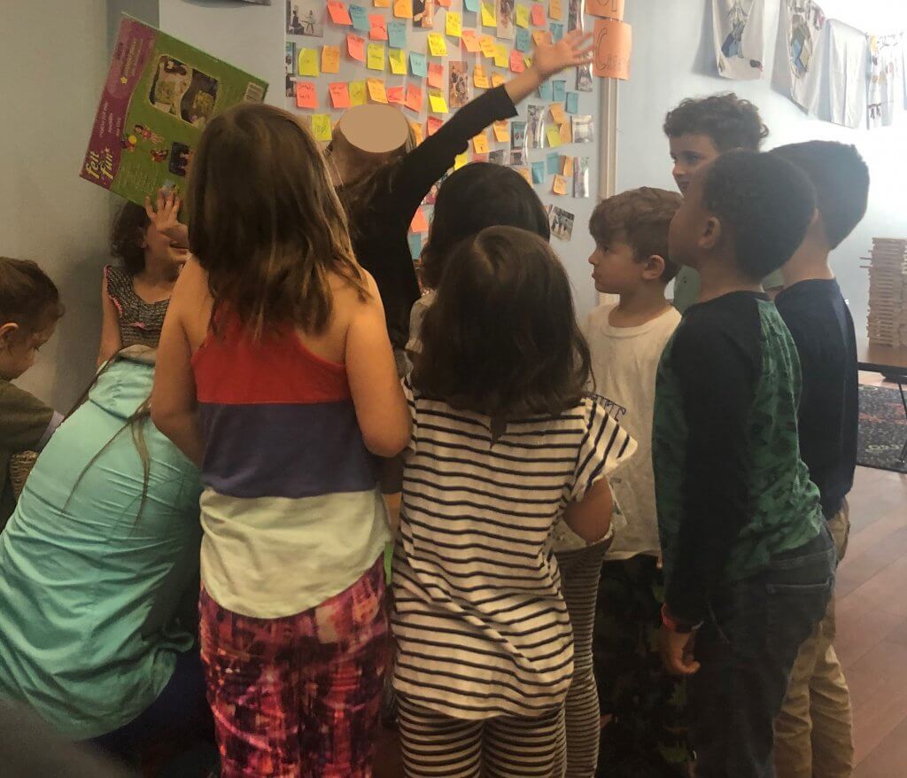 Kids gathered by felt board storyteller.