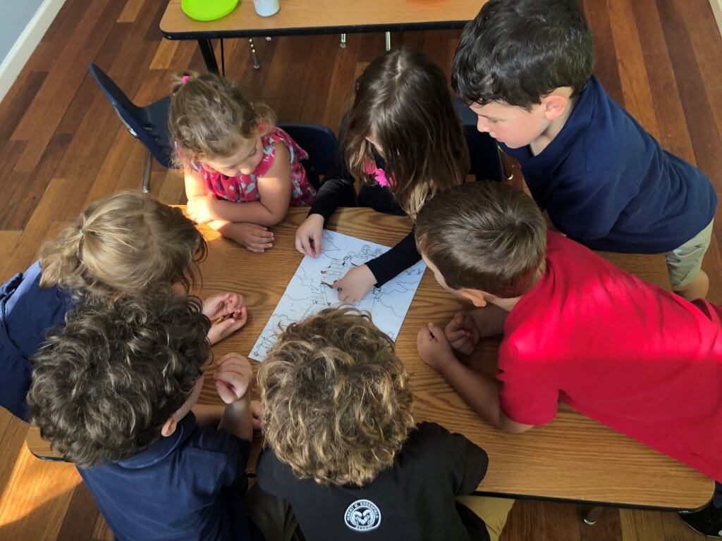 Garinim (pre-K and K students) completing a puzzle together