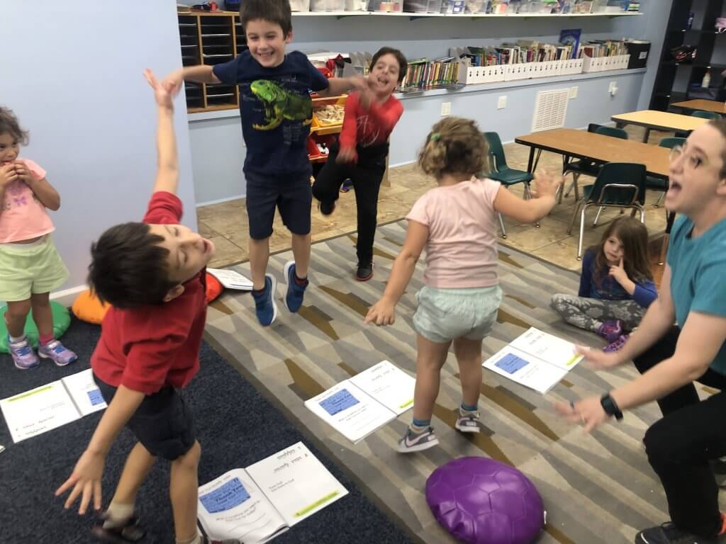 Kiddos jumping joyfully during Tefilah: Prayer, Music, and Movement.