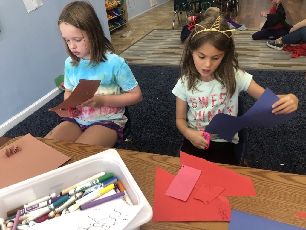 Two nitzanim (2nd-4th graders) working on floors of a skyscraper craft.