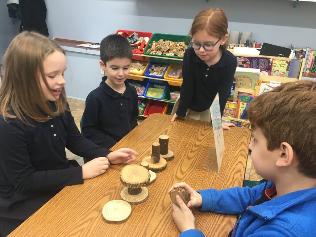 Four students build a block creation as they explore compassion with a drama activity.