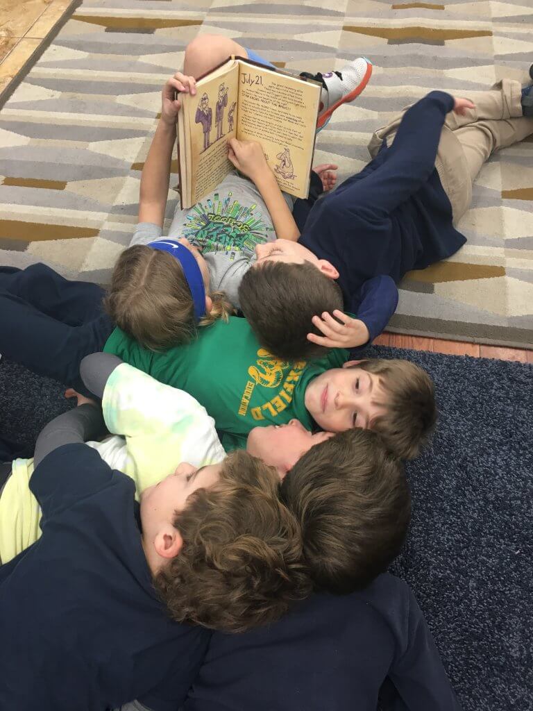 Cuddle pile of kiddos on the carpets.