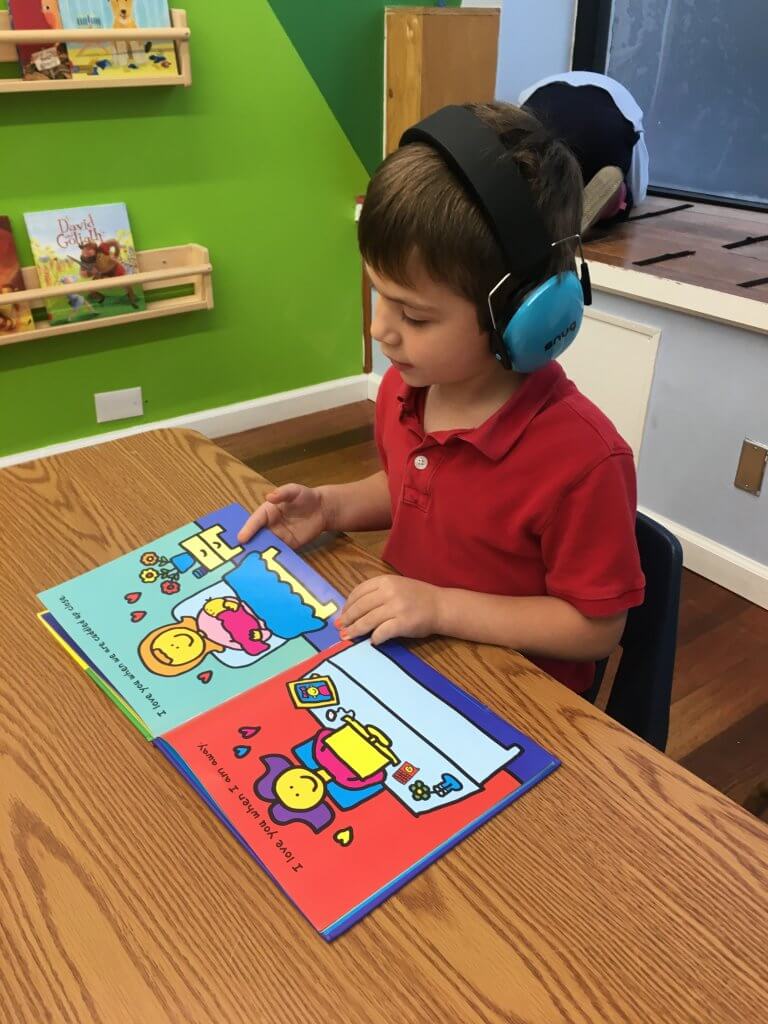 Kindergartner reads a book all about love.