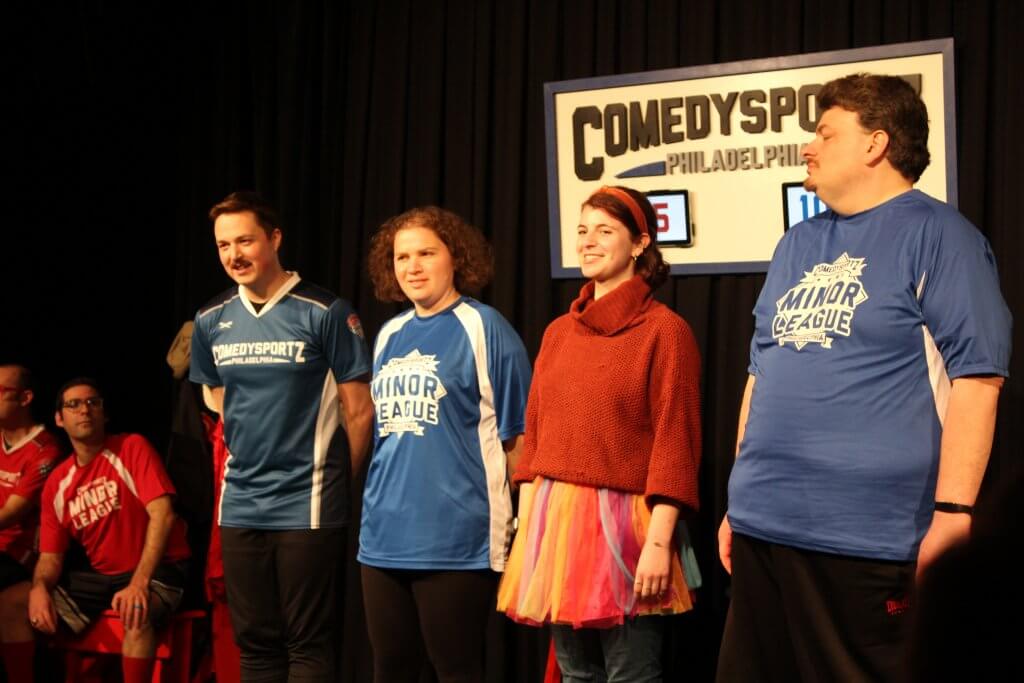 Noa on stage participating in an improv game with one of the CSz teams.