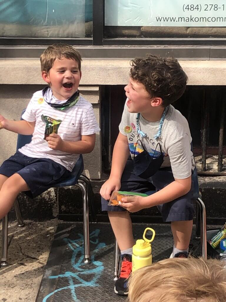 A first grader and preschooler excitedly call "tekiya" to hear the shofar blast