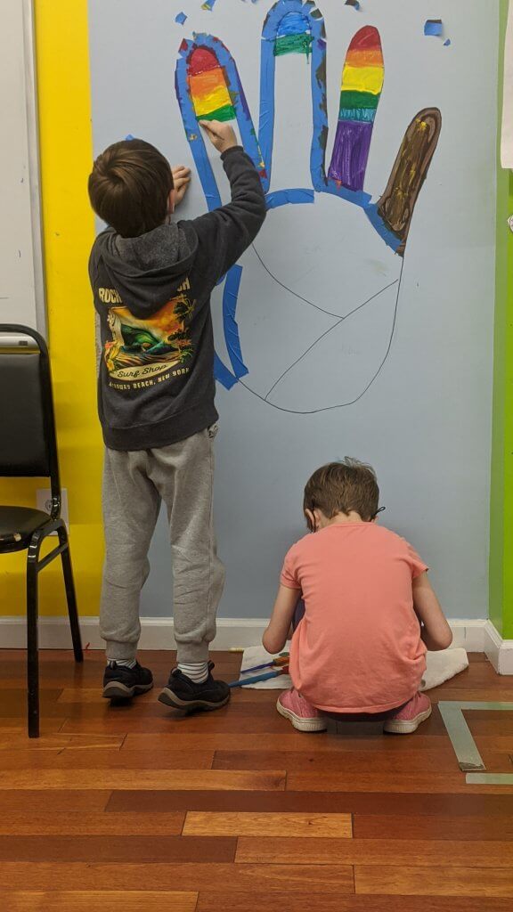 First and second graders painting their brit background