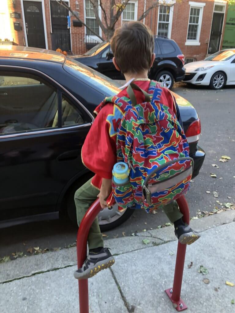 2nd grader sitting on a bike rack outside Chester Arthur.