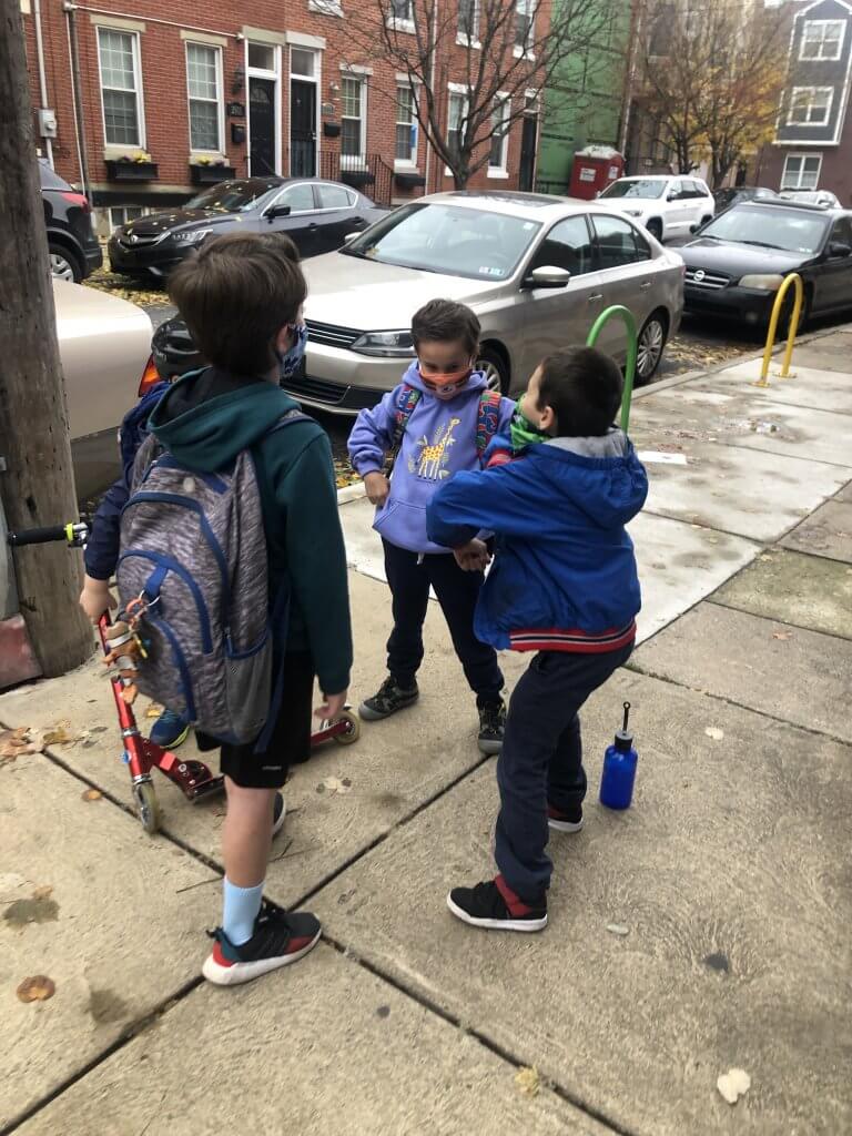 2nd and 3rd graders working on a group handshake