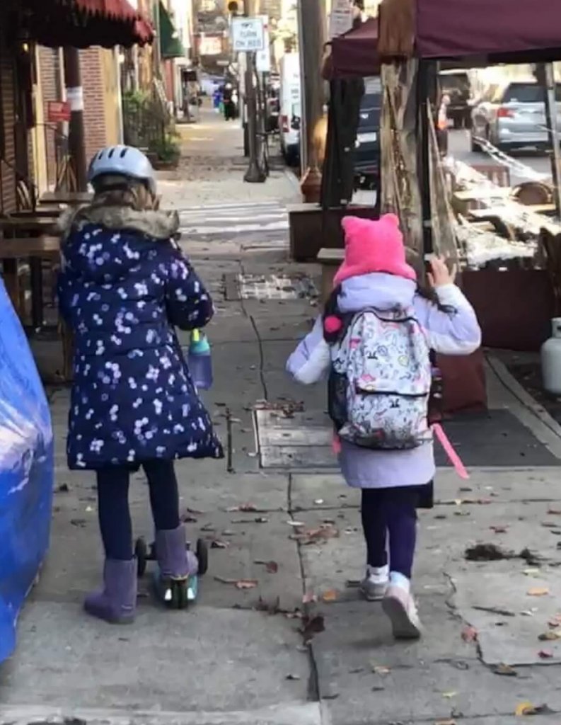 Two third graders on their way to outdoor class.