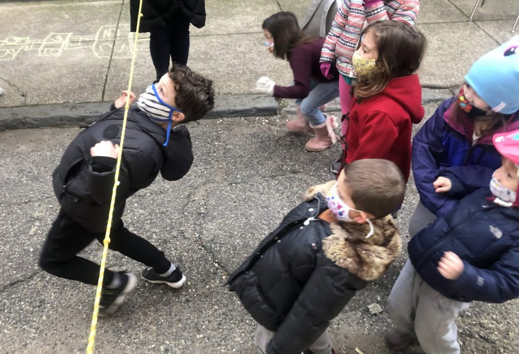 PreK and K kids playinig limbo