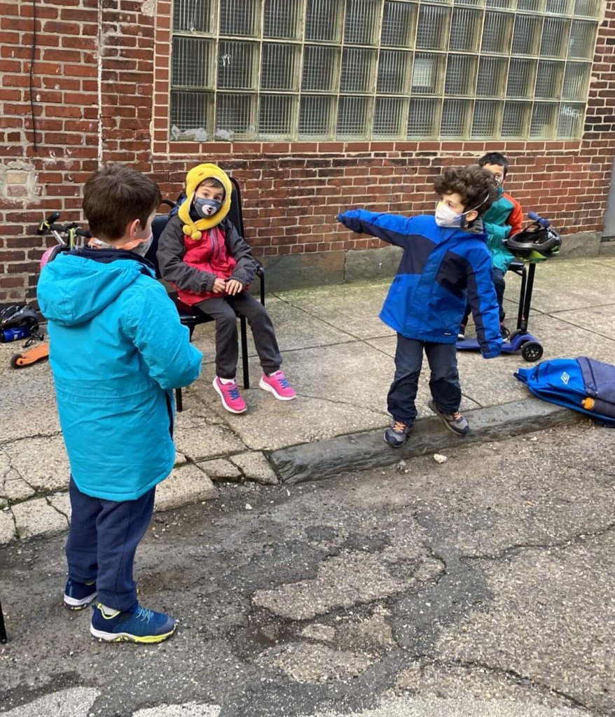 1st and 2nd graders at class outside.