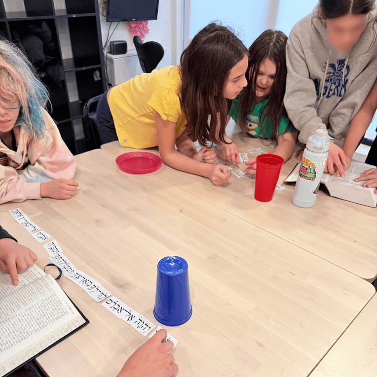 The two groups of kiddos using different strategies to finish the scavenger hunt.